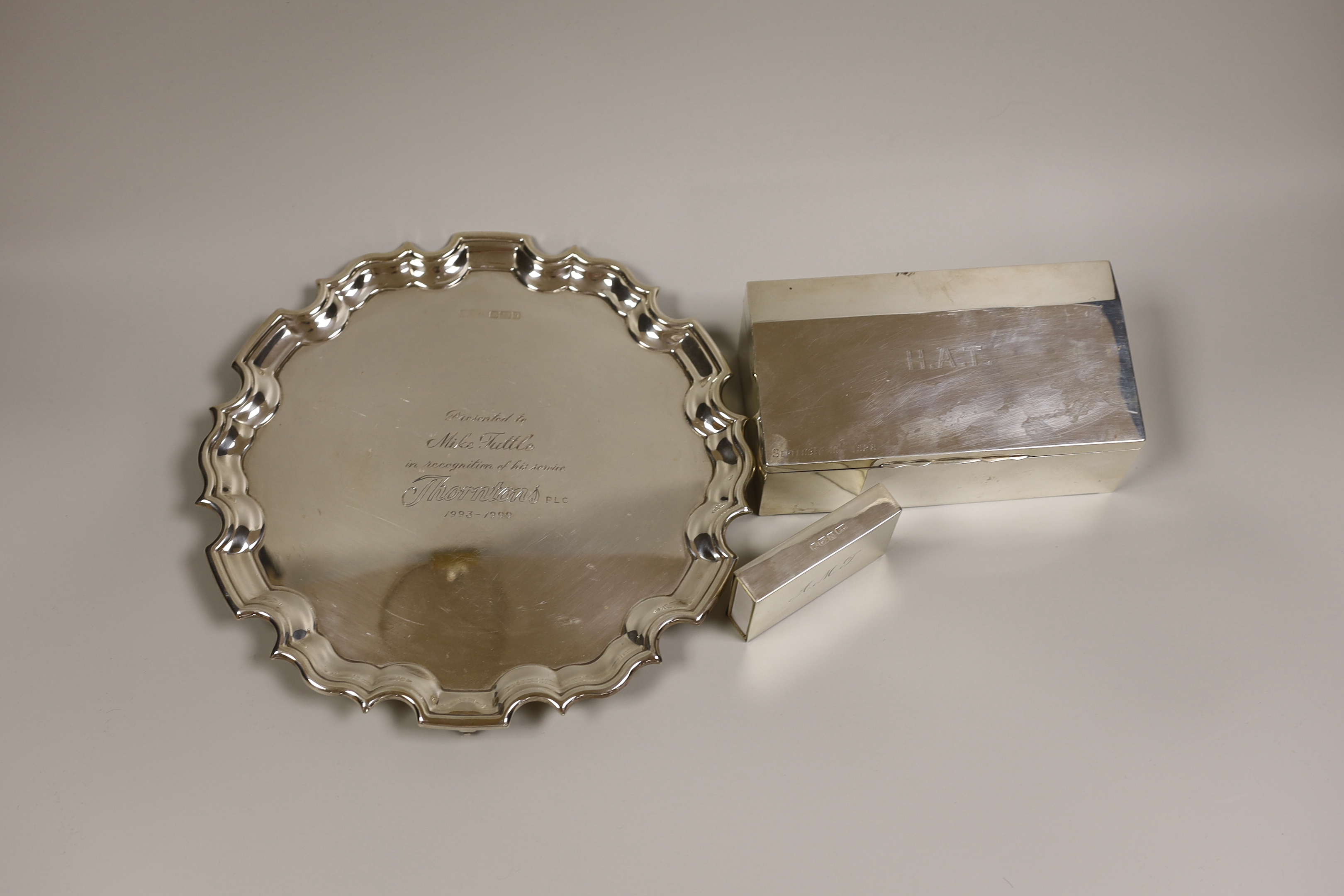 A modern silver presentation salver, inscribed; Sheffield, 1998, 17oz, and a silver matchbox case holder (3)